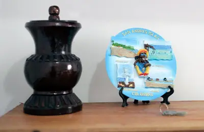 a figurine of a horse on a table next to a vase at Casa Edith in Cartagena de Indias
