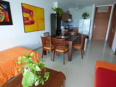 a kitchen and dining room with a table and chairs at Costa Azul Suites 802 in Santa Marta