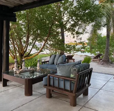 a couch and a coffee table on a patio at Cabana SalSiPuedes in Tintipan Island