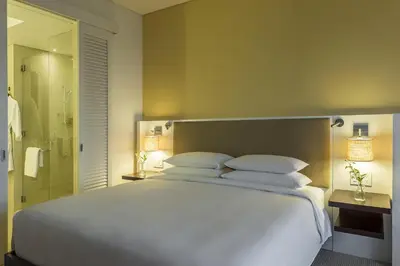 a bedroom with a large white bed and a shower at Hyatt Regency Cartagena in Cartagena de Indias