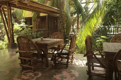 a wooden table and chairs on a patio at Isla Fuerte Eco House in Isla Fuerte