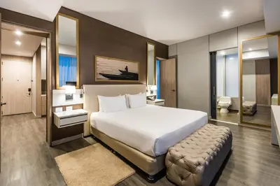 a bedroom with a large bed and a bathroom at Crowne Plaza Barranquilla by IHG in Barranquilla