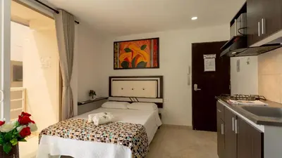 a bedroom with a bed with a dog laying on it at Hollywood Beach Suite in Cartagena de Indias
