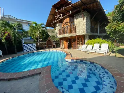 a swimming pool in front of a house at Cabana Dubai Resorts in Santa Veronica