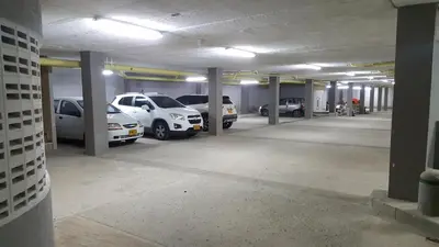 a parking garage with cars parked in it at Hotel 56 Avenue Plaza in Barranquilla