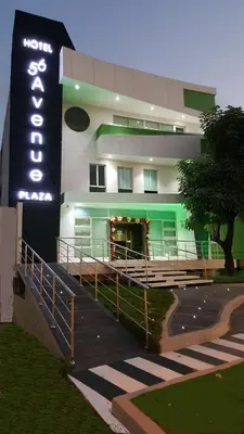 a building with a sign in front of it at Hotel 56 Avenue Plaza in Barranquilla