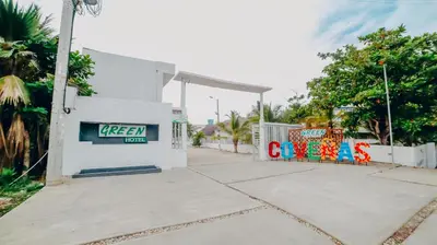 a sign on the side of a building with graffiti at Green Coveñas by Bernalo Hotels in Coveñas