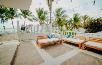 two benches sitting on a patio near the beach at Green Coveñas by Bernalo Hotels in Coveñas