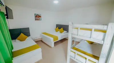 a room with two bunk beds and a couch at Green Coveñas by Bernalo Hotels in Coveñas