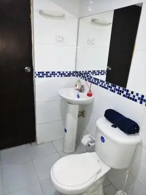 a bathroom with a white toilet and a sink at Apartamento Marbella #2-14 in Cartagena de Indias