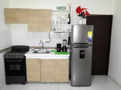 a kitchen with a stainless steel refrigerator and a stove at Apartamento Marbella #2-14 in Cartagena de Indias