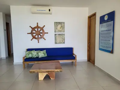a blue couch and a table in a room at Condominio Milagros Coveñas in Coveñas