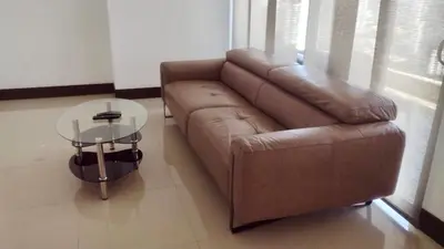 a living room with a brown couch and a glass table at Pretty Apartment in Cartagena de Indias