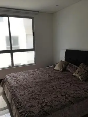 a bedroom with a large bed with a large window at Pretty Apartment in Cartagena de Indias