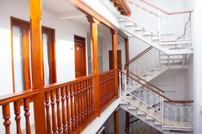 a spiral staircase in a house with wooden railings at Akel House Hotel in Cartagena de Indias