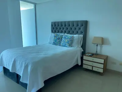 a bedroom with a large bed with a blue light at Apartamentos en Morros Cartagena in Cartagena de Indias
