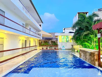 a swimming pool in the middle of a house at Awa De Mar Hotel Tolu in Tolú