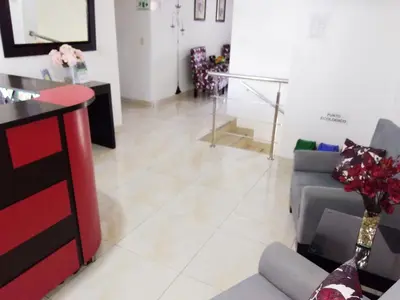 a living room with a couch and a table at Hotel Cosmos Sincelejo in Sincelejo