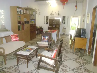 a living room filled with furniture and a tv at Hostal Santa Clara in San Antero