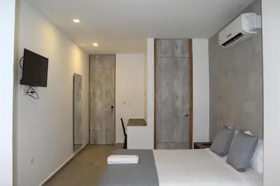 a bedroom with a bed and a tv on the wall at Hotel Hausen in Lorica