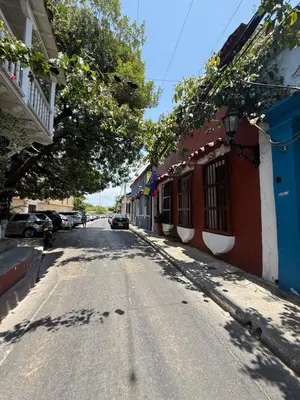 an empty street in a town with buildings and trees at Casa Colonial Serrezuela in Cartagena de Indias