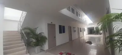 a hallway with stairs and potted plants in a building at Hotel Don Toño Tolú in Tolú