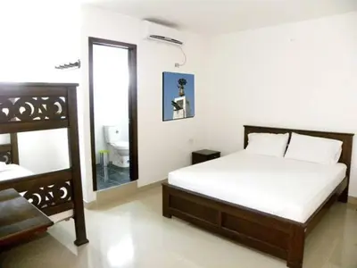 a bedroom with a bed with a mirror and a sink at Hotel Diamante Real Cienaga in Ciénaga