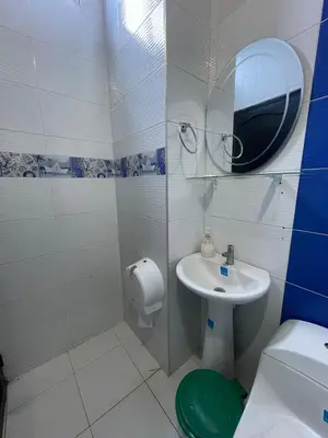 a bathroom with a sink and a toilet and a mirror at Cabanas Villa Antonella Covenas in Coveñas