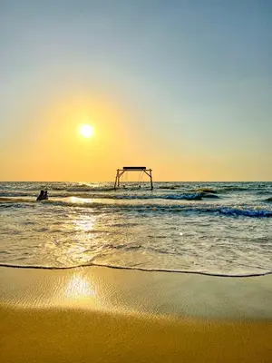 a beach with the sun rising over the ocean at Hotel Camino Verde in Tolú