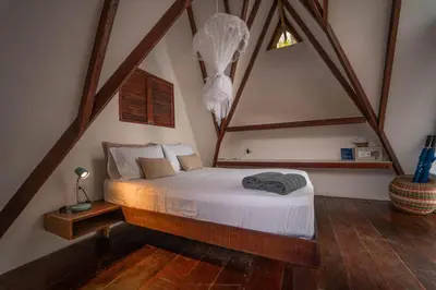 a bedroom with a bed in a attic at Hotel Islabela Islas Del Rosario in Isla Grande
