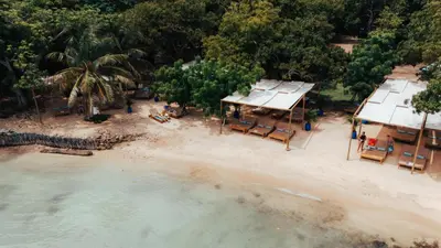 an aerial view of a beach with chairs and houses at Hotel Islabela Islas Del Rosario in Isla Grande