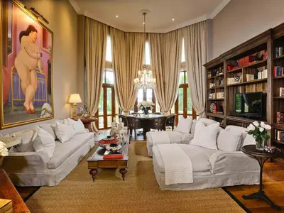 a large living room with white couches and a table at Sofitel Legend Santa Clara Cartagena in Cartagena de Indias