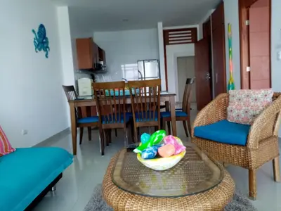 a living room with a table and chairs and a bowl at Costa Azul Suites 1002 in Santa Marta
