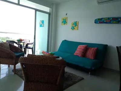 a living room with a blue couch and chairs at Costa Azul Suites 1002 in Santa Marta