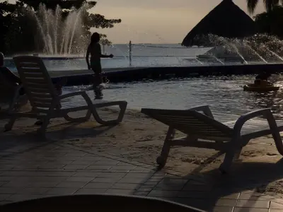 a woman is standing in front of a fountain at Costa Azul Suites 1002 in Santa Marta