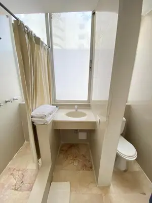 a bathroom with a sink and a toilet and a window at Hotel Cartagena Premium in Cartagena de Indias