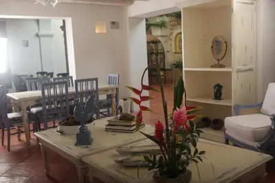 a living room with a table and chairs at Hotel Casa Quero in Cartagena de Indias