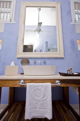 a bathroom with a white sink and a mirror at Hotel Casa Quero in Cartagena de Indias