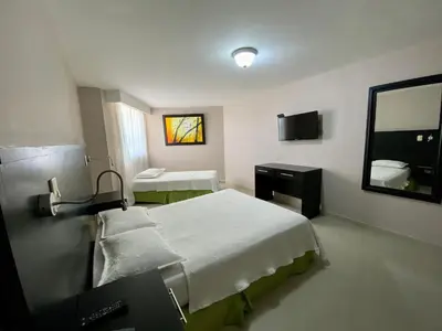 a hospital room with two beds and a mirror at Hotel Dorado Plaza Bocagrande - All Inclusive in Cartagena de Indias