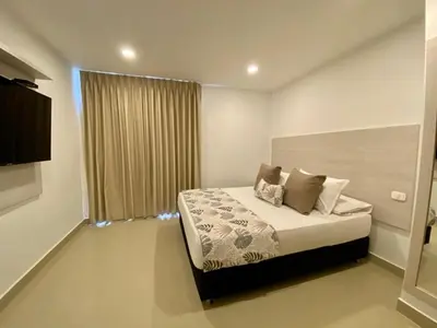 a bedroom with a bed and a large window at Hotel Dorado Plaza Bocagrande - All Inclusive in Cartagena de Indias