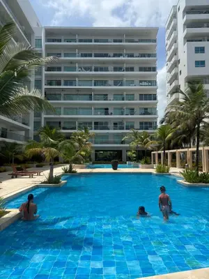 a group of people in a swimming pool in front of a building at Apartamento Cartagena Morros Epic 23 in Cartagena de Indias