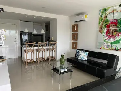 a living room with a black couch and a table at Apartamento Cartagena Morros Epic 23 in Cartagena de Indias
