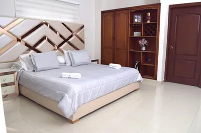 a bedroom with a bed with two towels on it at Hotel Dainner in Plato