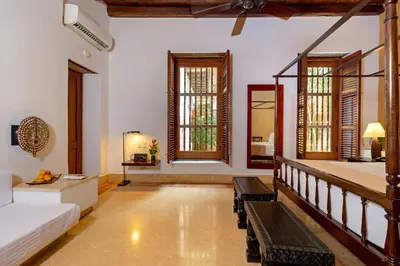 a living room with a couch and some windows at Hotel Quadrifolio in Cartagena de Indias