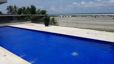 a blue swimming pool with a view of the beach at Morros Epic 222 in Cartagena de Indias