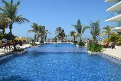 a swimming pool at a resort with palm trees at Morros Epic 222 in Cartagena de Indias