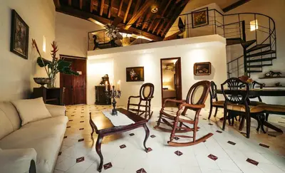 a living room with a couch and a table and chairs at Alfiz Hotel in Cartagena de Indias