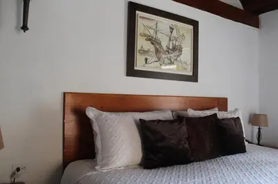 a bedroom with a bed with a picture on the wall at Life is Good Cartagena Hostel in Cartagena de Indias