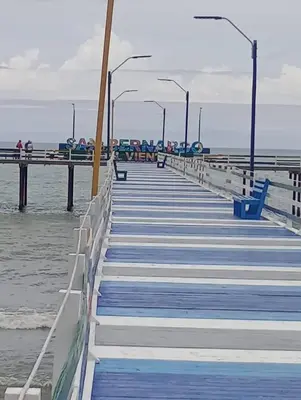 a wooden boardwalk leading to the water on a pier at Gran Muelle Hotel in San Bernardo del Viento