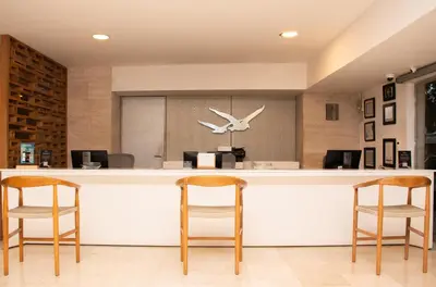 an office with a bar with two chairs and a plane on the wall at Hotel Capilla del Mar in Cartagena de Indias